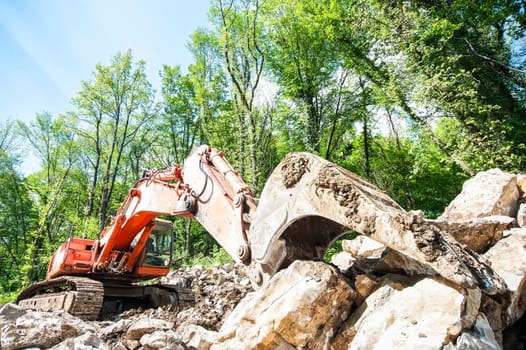 Excavator with big shovel to work with rocks
