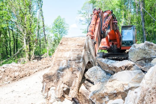 Excavator with big shovel to work with rocks