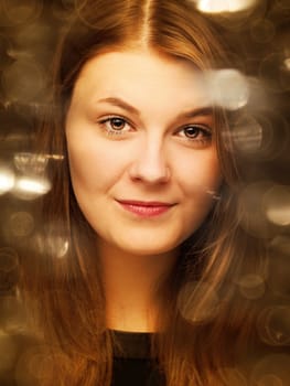 Glamorous retro film style beauty portrait with bokeh effects in gold