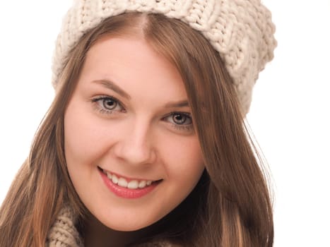 Attractive teenage girl dressed with wool cap and scarf on a white background