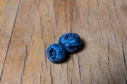 Blueberries on a blue wooden background, close up