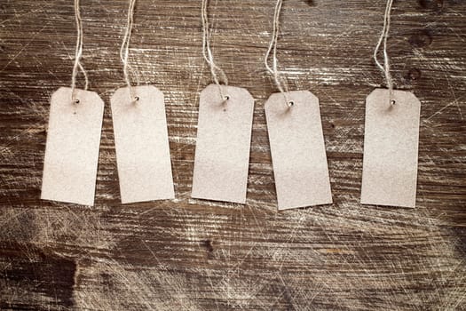 blank tags on the wooden background with copy-space