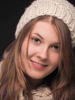 Attractive young woman dressed with wool cap and scarf
