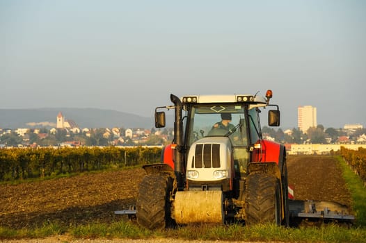 Tractor while harrowing in the field
