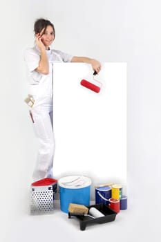 Decorator using a cellphone next to a blank board