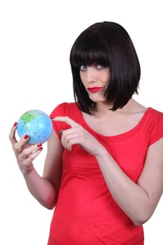 woman holding a globe and making a funny face