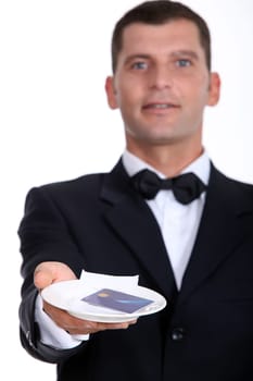 Male waiter holding credit-card and receipt