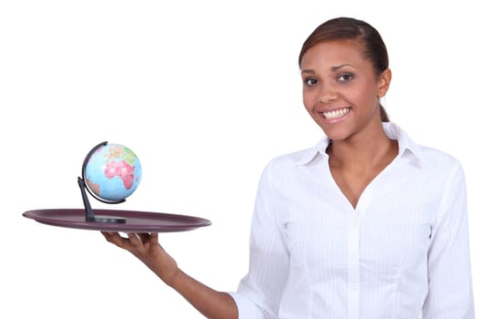 Woman holding miniature globe on tray