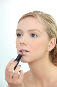 Woman applying lipstick