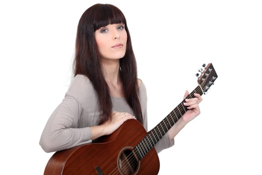 Woman playing acoustic guitar