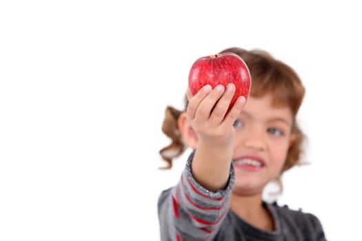 Little girl holding red apple