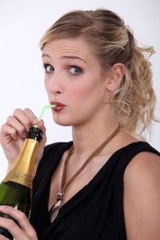 woman drinking champagne through a straw