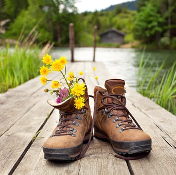Hiking boots at the mountain lake