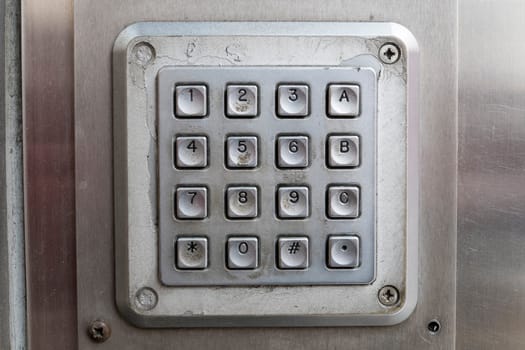Detail shot of dirty metal number keypad