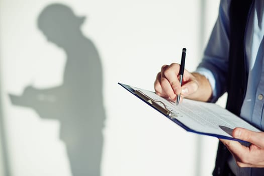 Male employee signing business contract in isolation