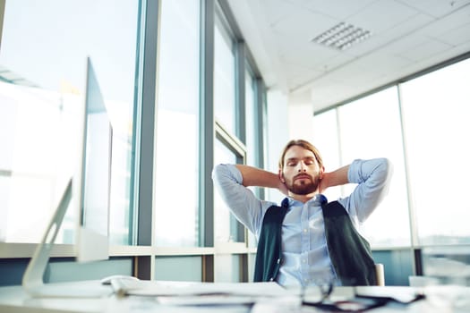 Calm businessman having a minute of rest in office