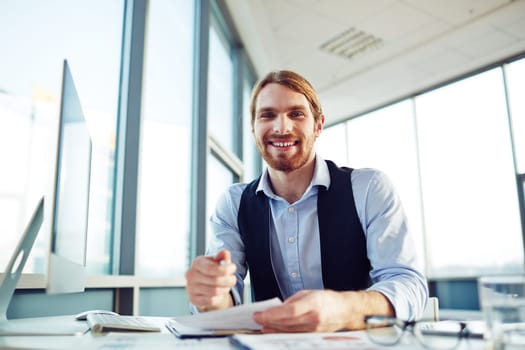 Cheerful young manager working in office