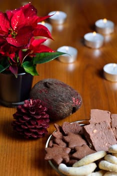 Christmas decoration with poinsettia, cookies and candles