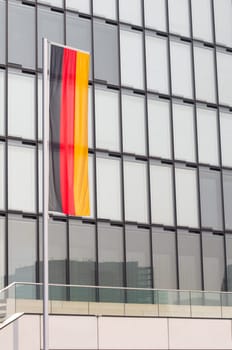 german flag in front of a modern hotel