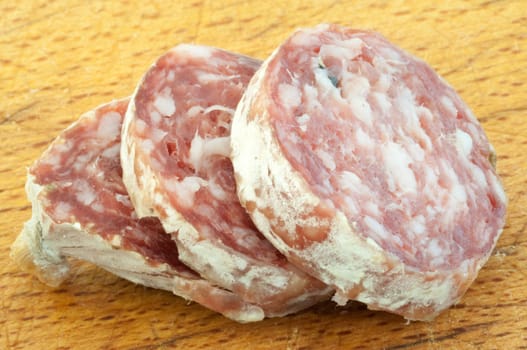 beautiful background of salami cutted with a wood background