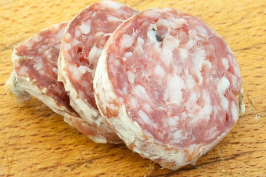beautiful background of salami cutted with a wood background
