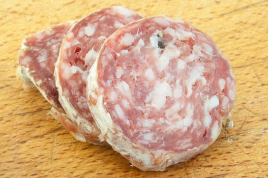 beautiful background of salami cutted with a wood background