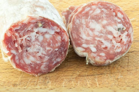 beautiful background of salami cutted with a wood background