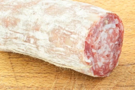 beautiful background of salami cutted with a wood background