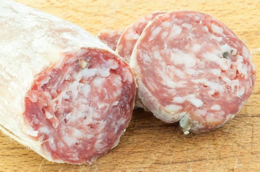 beautiful background of salami cutted with a wood background