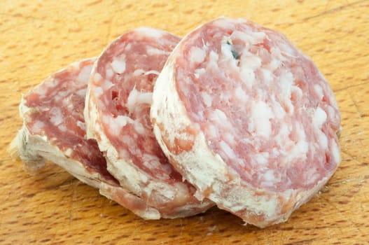 beautiful background of salami cutted with a wood background