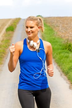 Young woman jogging with MP3 Player