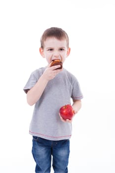 little boy with food isolated on white background - apple or a muffin