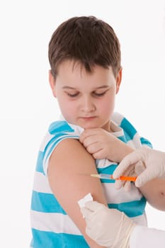 Doctor giving a child injection in arm on isolated image.