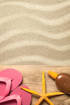 summer concept with pink flip flops,yellow starfish and suntan oil on sandy beach