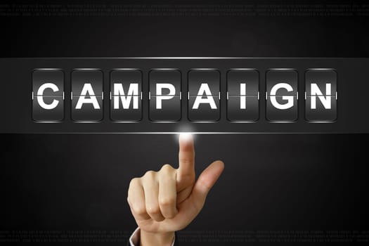 business hand pushing campaign on Flipboard Display