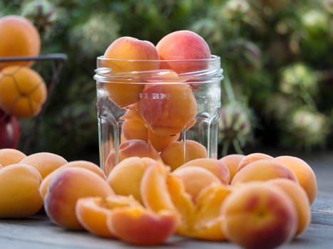 several apricots and glass jar on a table