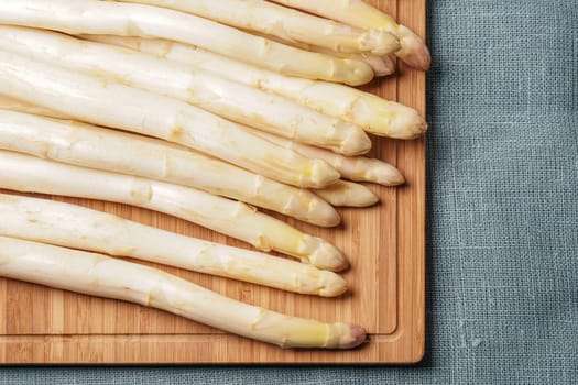 Delicate organic white asparagus ready to be peeled before they can be steamed