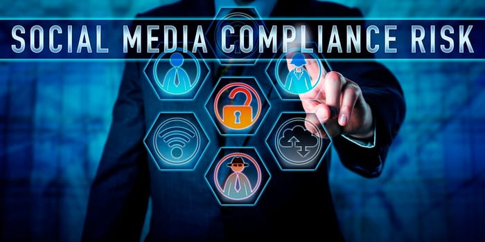 Manager is pushing SOCIAL MEDIA COMPLIANCE RISK on an interactive touch control screen. Business challenge metaphor and information technology concept for the pitfalls of corporate social networking.