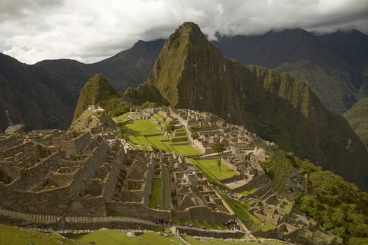 MACHU PICCHU, CUSCO, PERU - NOVEMBER 25, 2011: People Visiting Lost Incan City of Machu Picchu near Cusco in Peru. Peruvian Historical Sanctuary and UNESCO World Heritage Site.