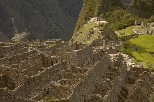 MACHU PICCHU, CUSCO, PERU - NOVEMBER 25, 2011: People Visiting Lost Incan City of Machu Picchu near Cusco in Peru. Peruvian Historical Sanctuary and UNESCO World Heritage Site.