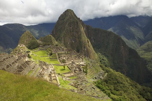 MACHU PICCHU, CUSCO, PERU - NOVEMBER 25, 2011: People Visiting Lost Incan City of Machu Picchu near Cusco in Peru. Peruvian Historical Sanctuary and UNESCO World Heritage Site.