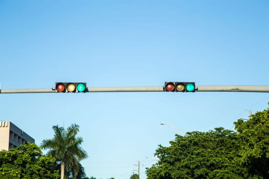 green  traffic lights under blue sky