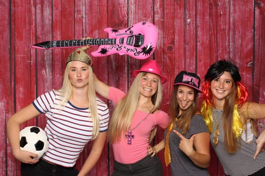 Funny women have fun with a photo box
