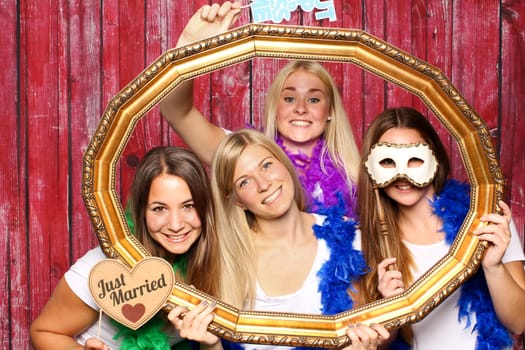Wedding party in front of a photo box