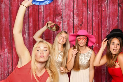 Young women silly in front of a photo box - have fun with Photo Booth