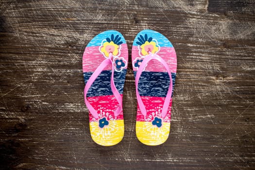 Flip flop sandals on old wooden floor. Top view .