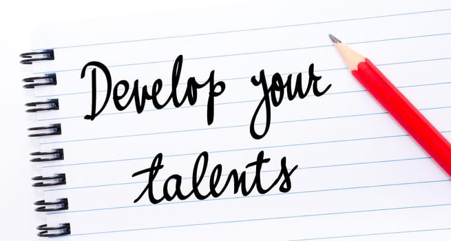 Develop Your Talents written on notebook page with red pencil on the right