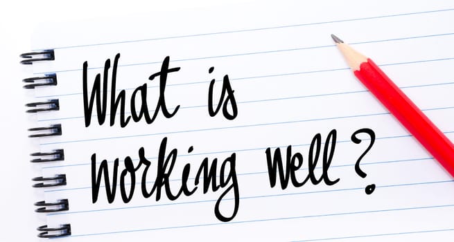 What Is Working Well ? written on notebook page with red pencil on the right