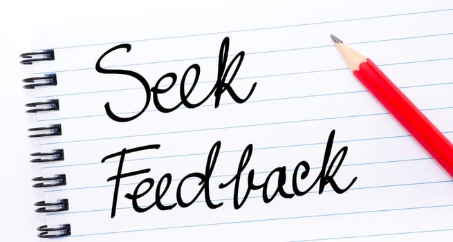 Seek Feedback written on notebook page with red pencil on the right