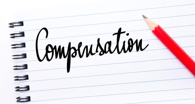 Compensation written on notebook page with red pencil on the right